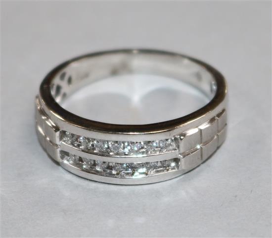 A modern 10ct white gold and two row channel set diamond half hoop ring, size W.